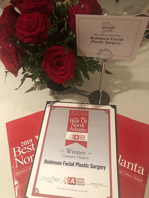 Award certificate with red roses centerpiece.
