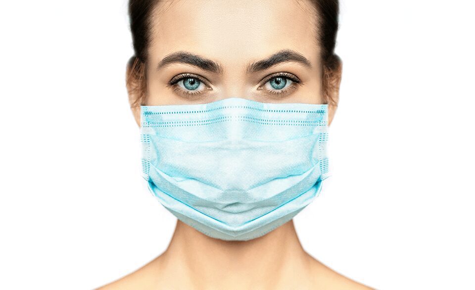 Person wearing a blue medical face mask.